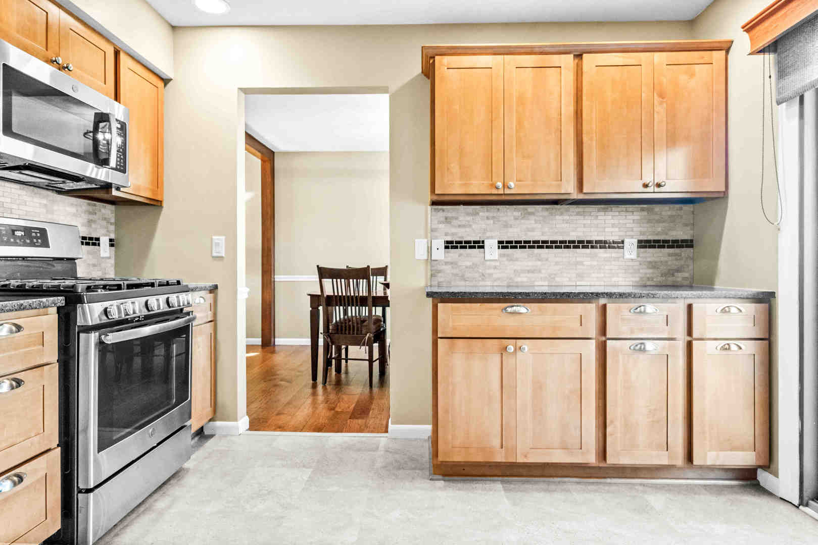 308 Raleigh Court Normal, IL 61761 - Photo 17 of 40 a kitchen with stainless steel appliances granite countertop a stove a sink and a microwave