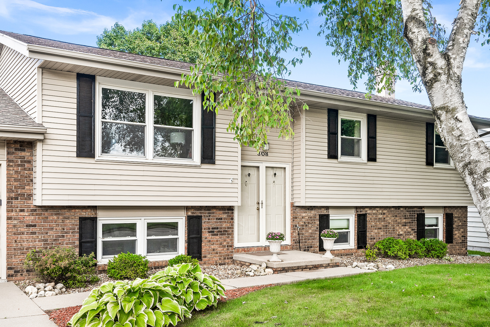 308 Raleigh Court Normal, IL 61761 - Photo 4 of 40 a front view of a house with a garden and plants