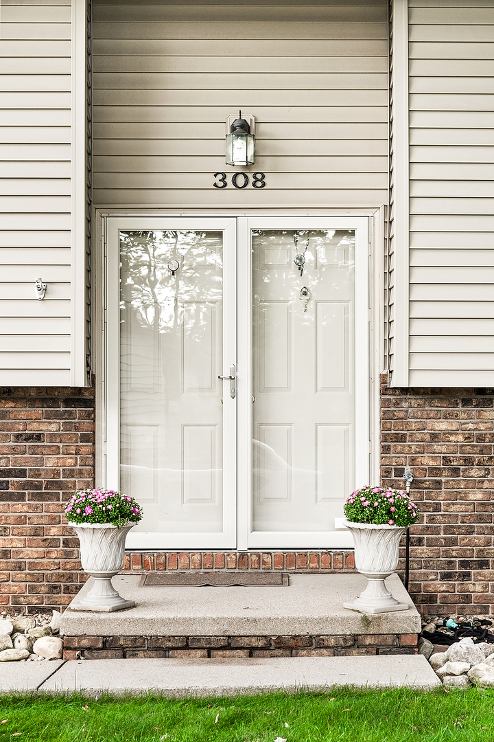 308 Raleigh Court Normal, IL 61761 - Photo 5 of 40 a front view of a house with a yard and garage