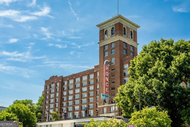 a view of a tall building next to a yard
