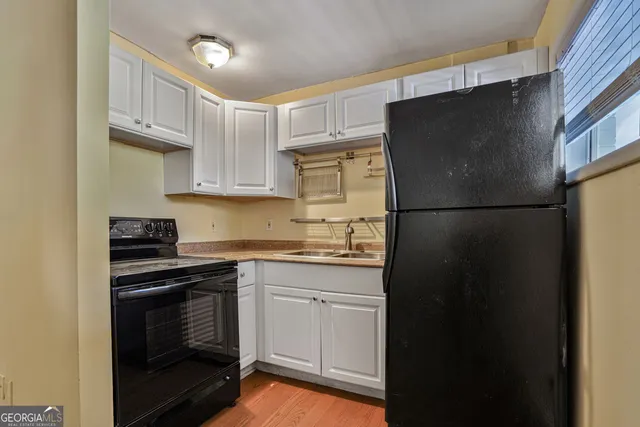 a kitchen with a sink stove and refrigerator