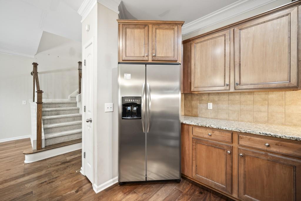 100 Trailside Way Hiram, GA 30141 - Photo 6 of 28 a kitchen with granite countertop a refrigerator and cabinets