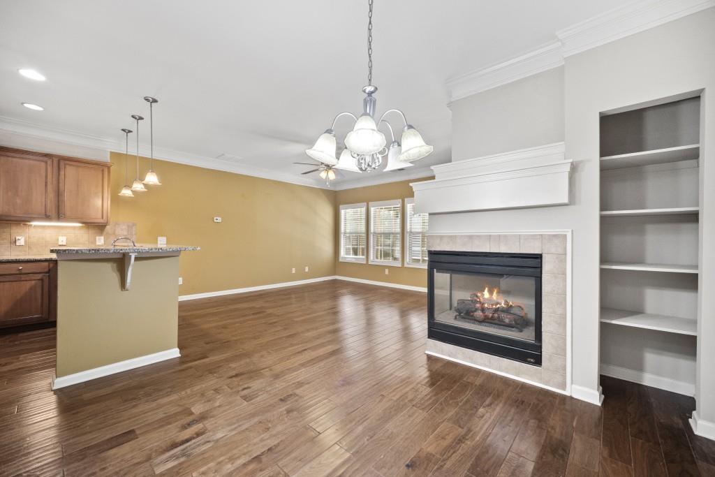 100 Trailside Way Hiram, GA 30141 - Photo 9 of 28 a open kitchen with fireplace and wooden floor