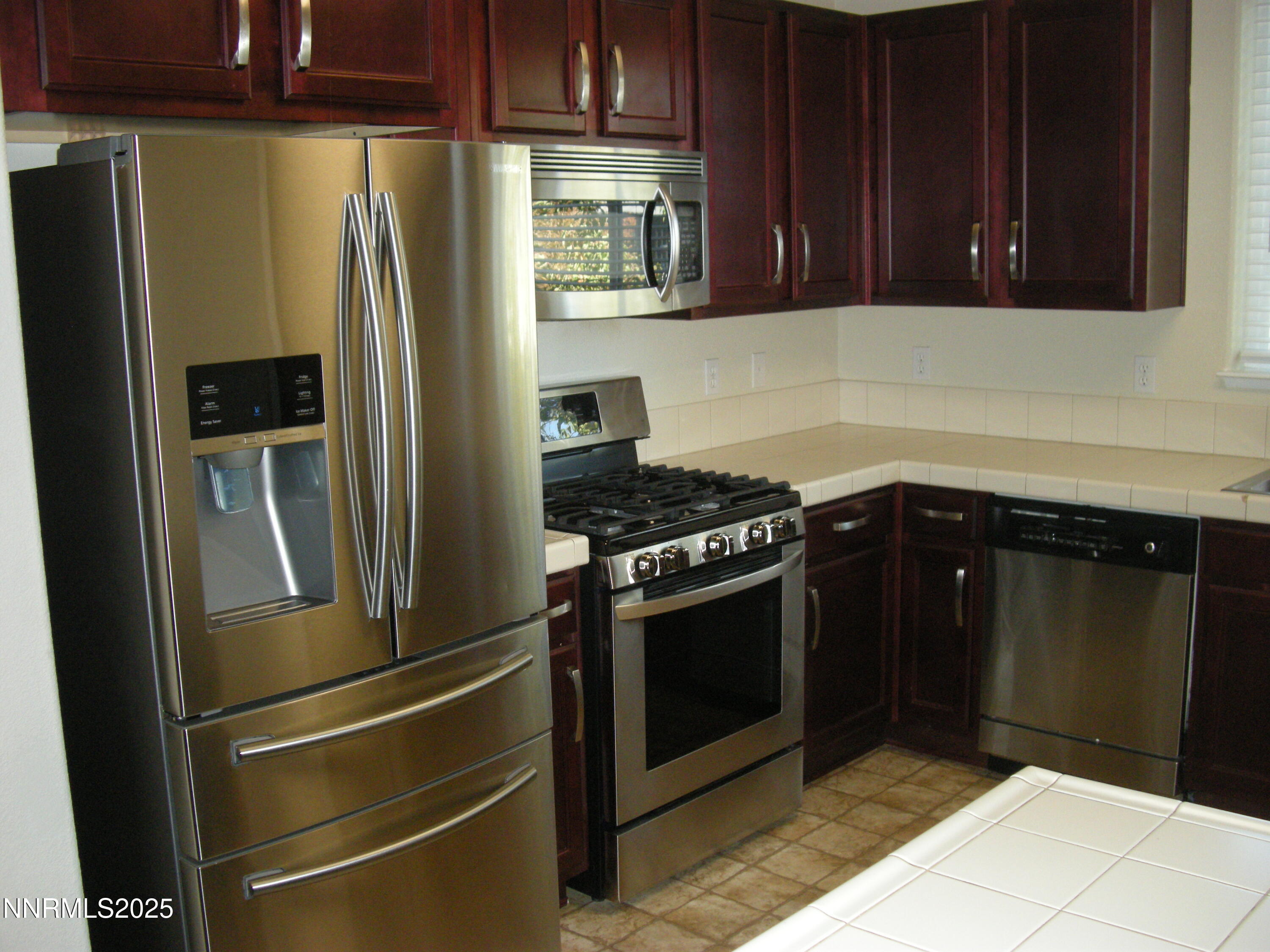 2640 Dana Kristin Lane Reno, NV 89503 - Photo 21 of 24 a kitchen with stainless steel appliances granite countertop a refrigerator and a sink