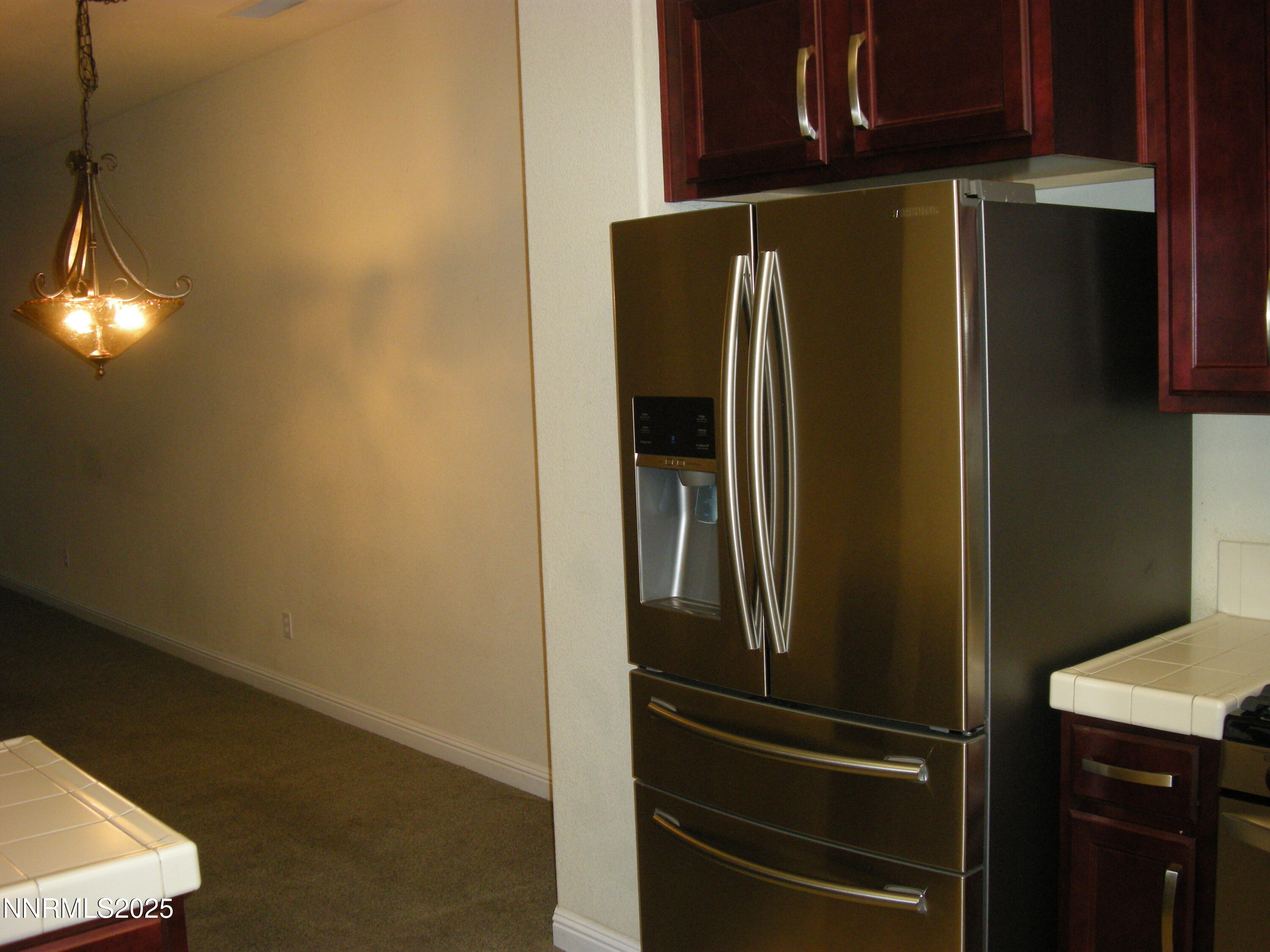 2640 Dana Kristin Lane Reno, NV 89503 - Photo 24 of 24 a metallic refrigerator freezer sitting in a kitchen
