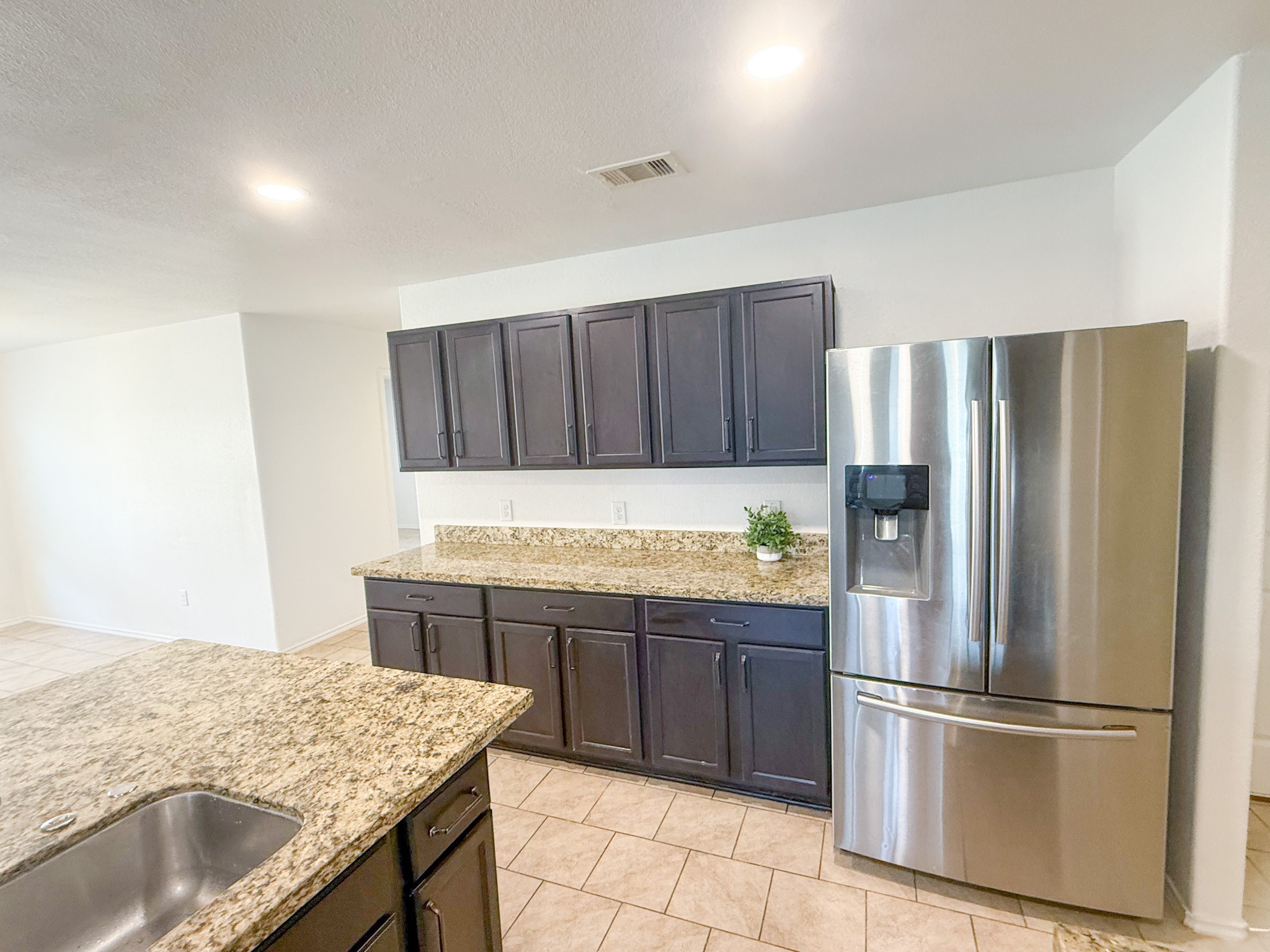 23319 Robbers Nest Drive Spring, TX 77373 - Photo 12 of 42 a kitchen with stainless steel appliances granite countertop a refrigerator and a sink