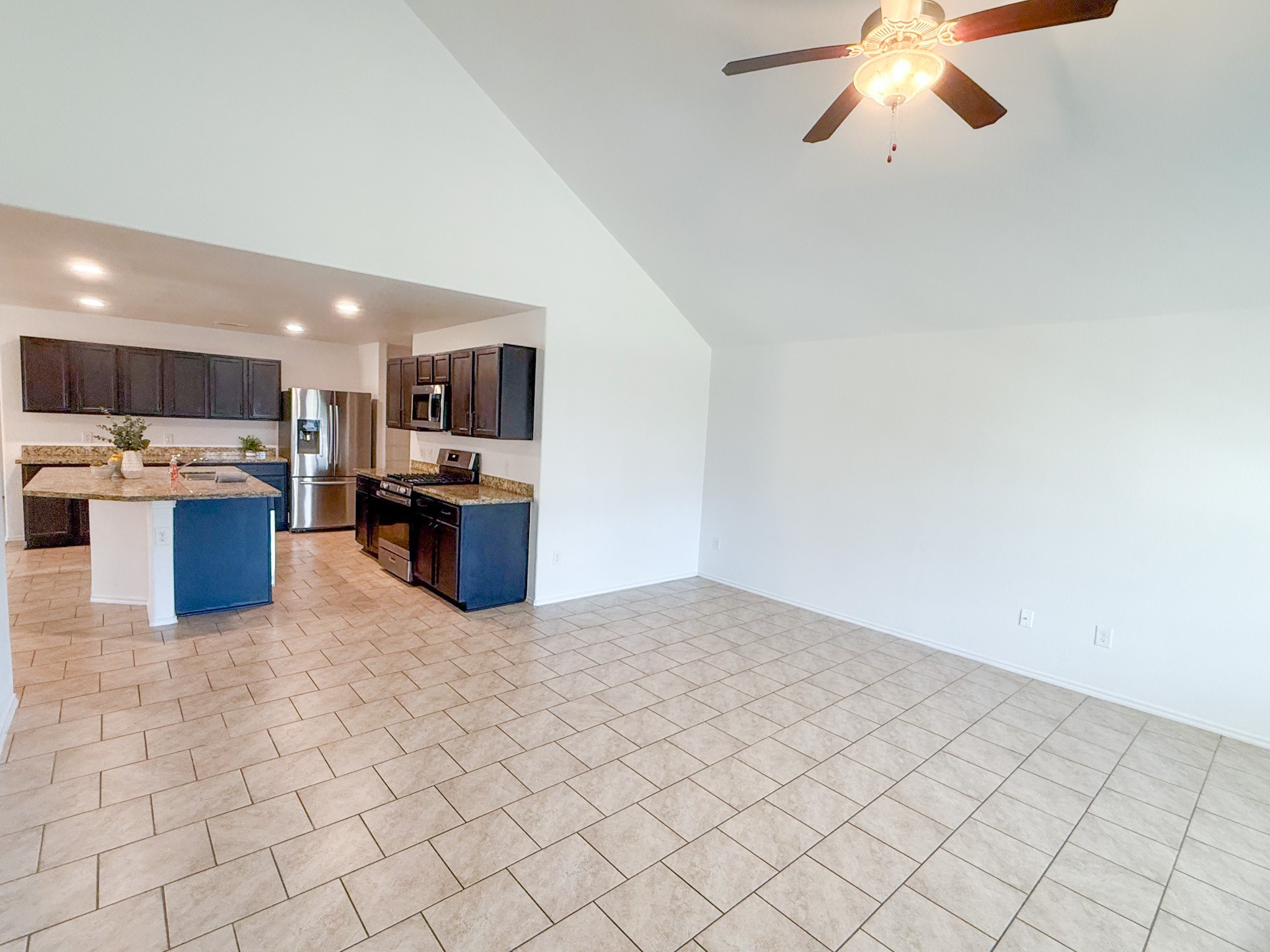 23319 Robbers Nest Drive Spring, TX 77373 - Photo 41 of 42 a kitchen with stainless steel appliances kitchen island granite countertop a refrigerator and a stove top oven