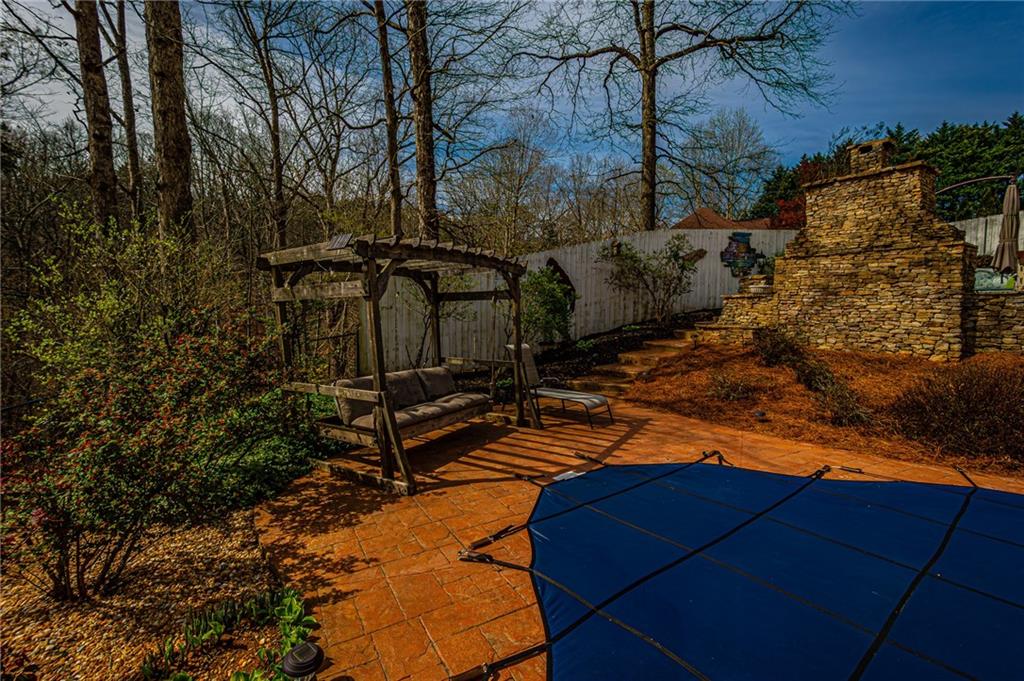 3718 Pebble Creek Point Gainesville, GA 30506 - Photo 121 of 144 a backyard of a house with table and chairs under an umbrella