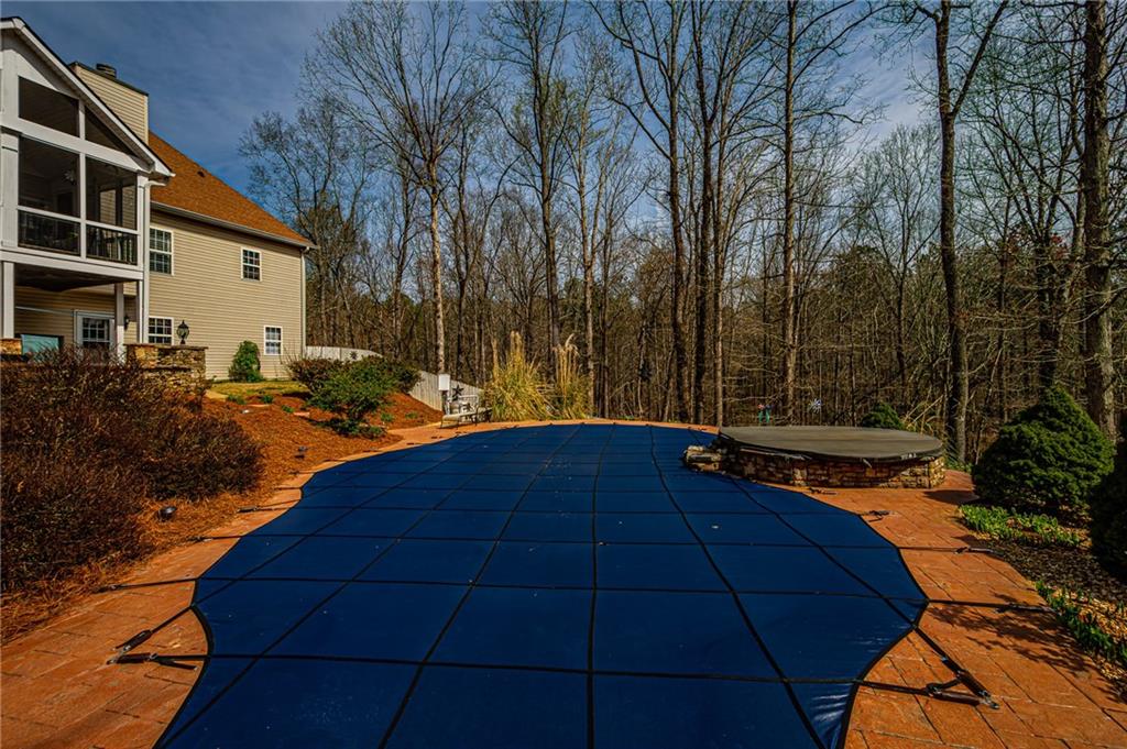 3718 Pebble Creek Point Gainesville, GA 30506 - Photo 123 of 144 a backyard of a house with trees and barbeque oven