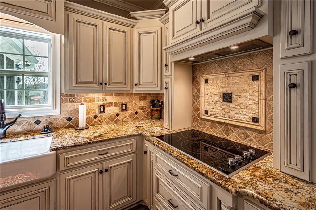 3718 Pebble Creek Point Gainesville, GA 30506 - Photo 14 of 144 a kitchen with granite countertop a sink stove and cabinets