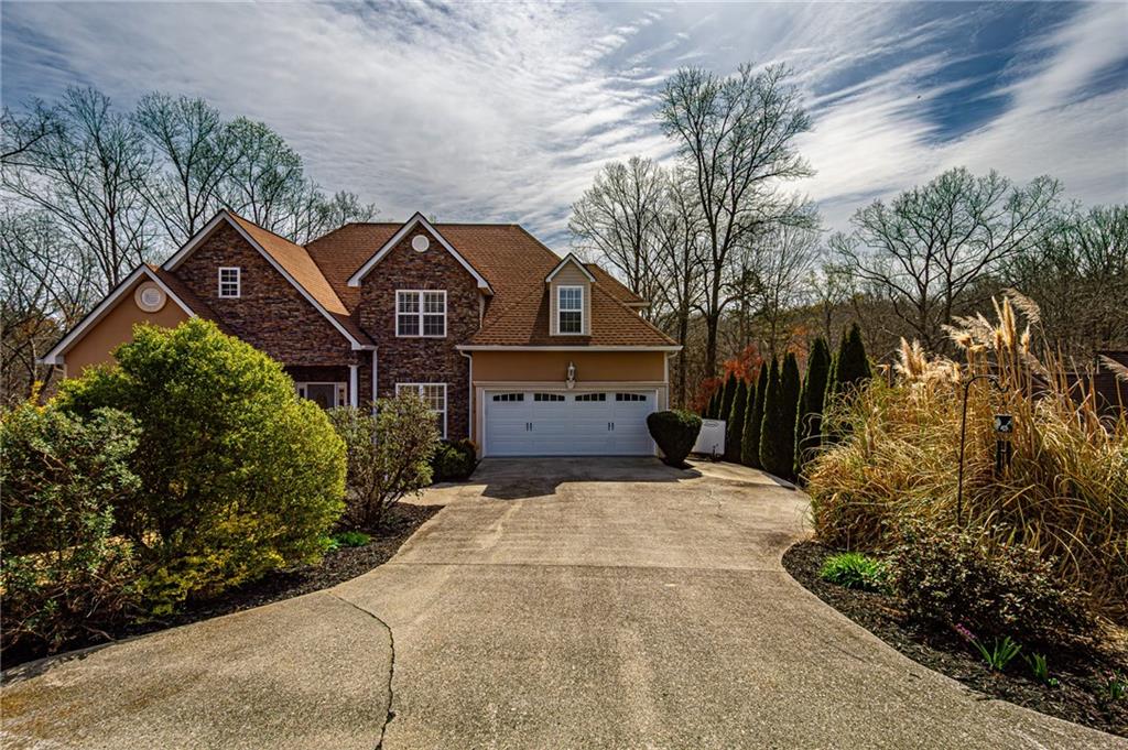 3718 Pebble Creek Point Gainesville, GA 30506 - Photo 141 of 144 a front view of a house with a yard and garage