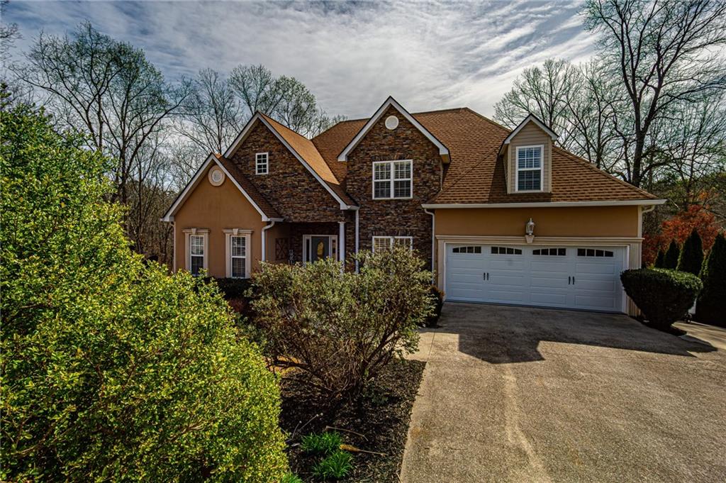 3718 Pebble Creek Point Gainesville, GA 30506 - Photo 142 of 144 a front view of a house with a yard and garage