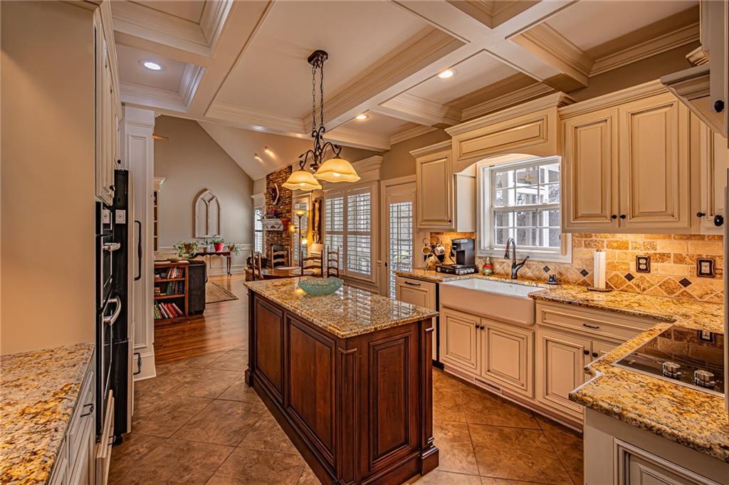 3718 Pebble Creek Point Gainesville, GA 30506 - Photo 18 of 144 a kitchen with stainless steel appliances granite countertop a sink counter space cabinets and a stove