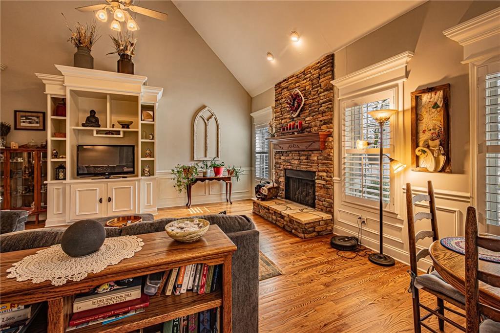 3718 Pebble Creek Point Gainesville, GA 30506 - Photo 24 of 144 a living room with furniture a flat screen tv and a fireplace