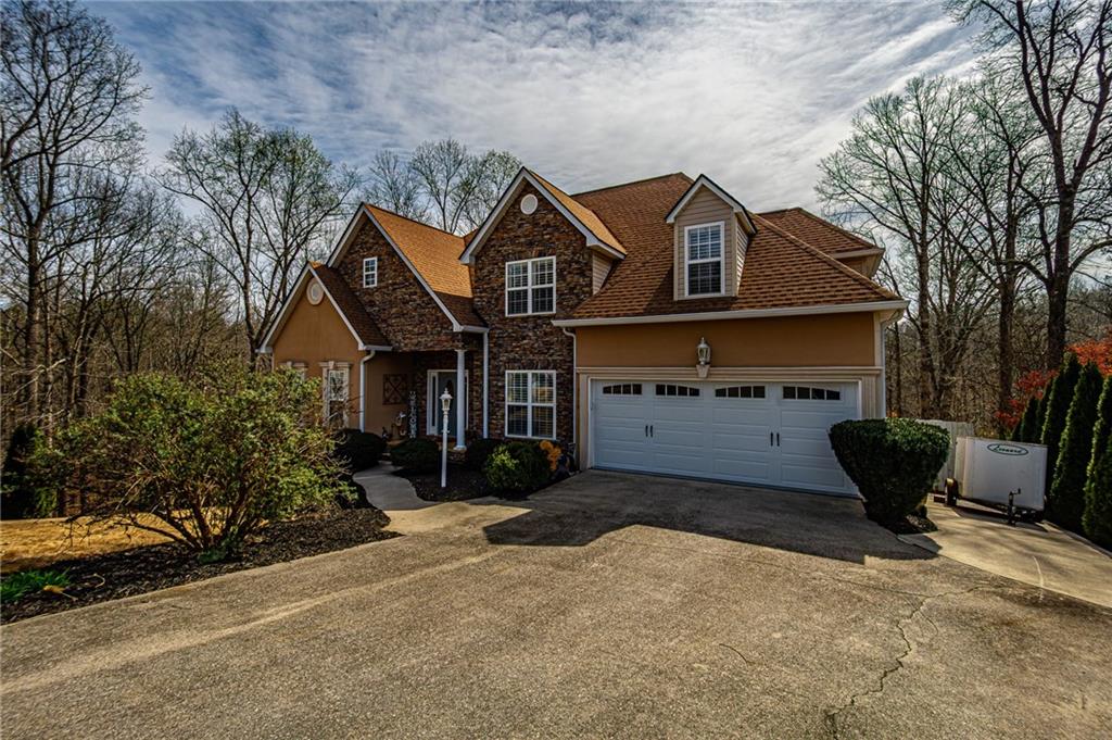 3718 Pebble Creek Point Gainesville, GA 30506 - Photo 3 of 144 a front view of a house with a yard and garage