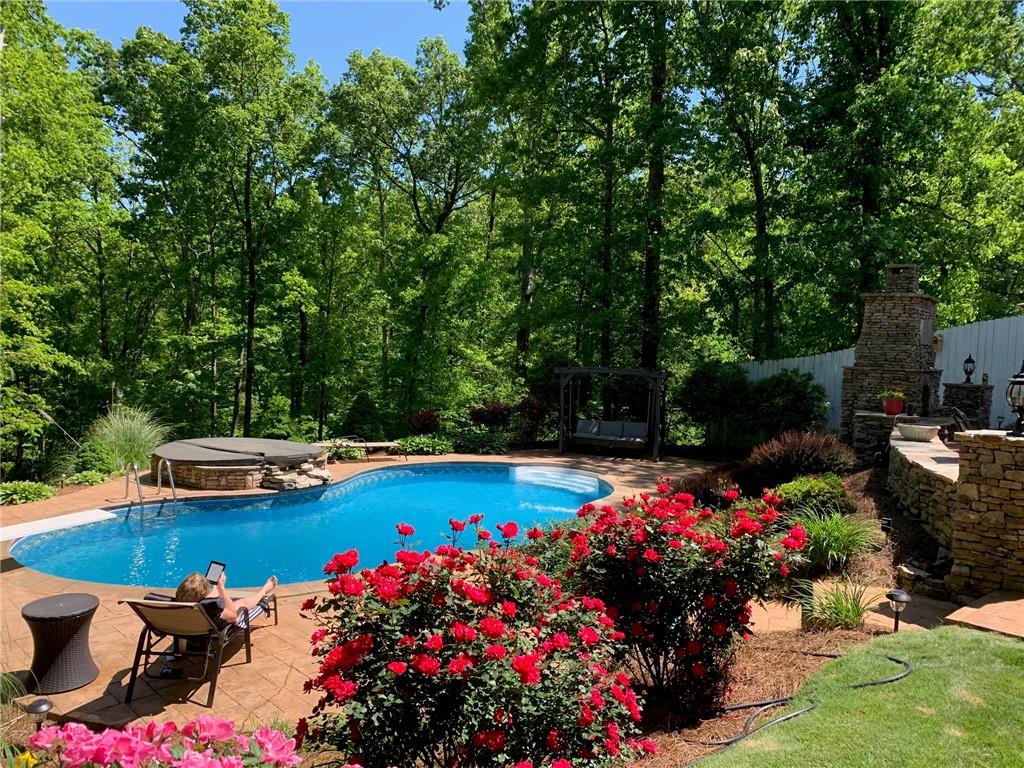 3718 Pebble Creek Point Gainesville, GA 30506 - Photo 4 of 144 a view of a swimming pool with a garden