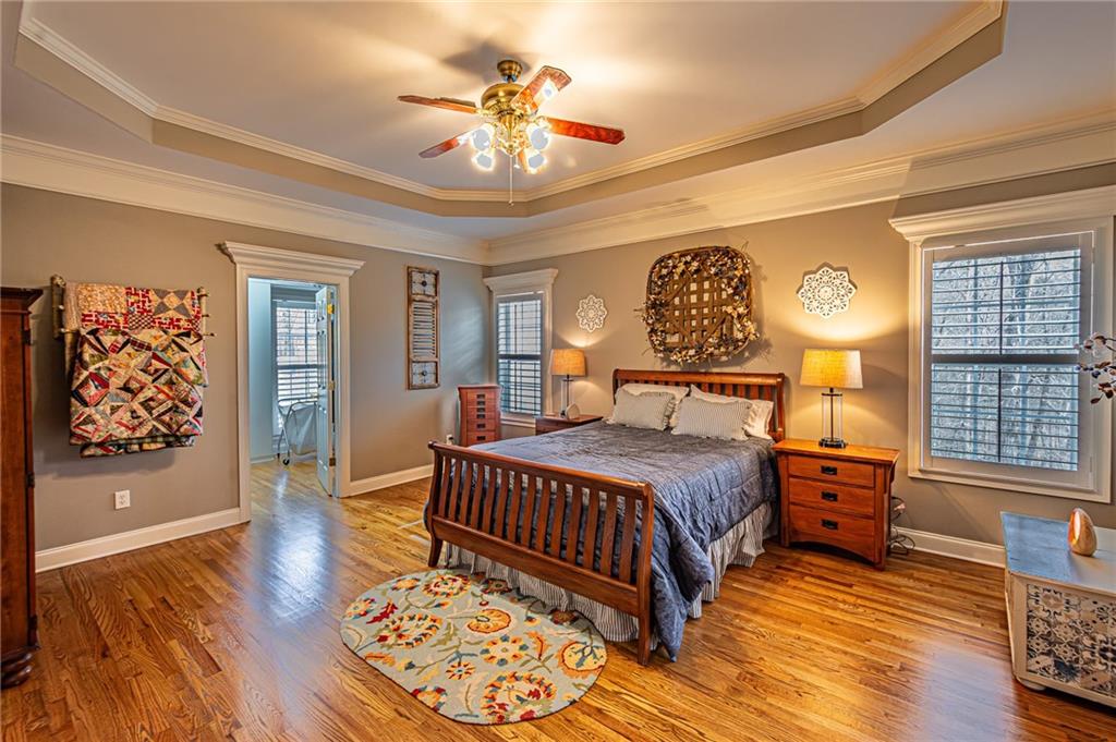 3718 Pebble Creek Point Gainesville, GA 30506 - Photo 41 of 144 a bedroom with a bed and dresser with wooden floor
