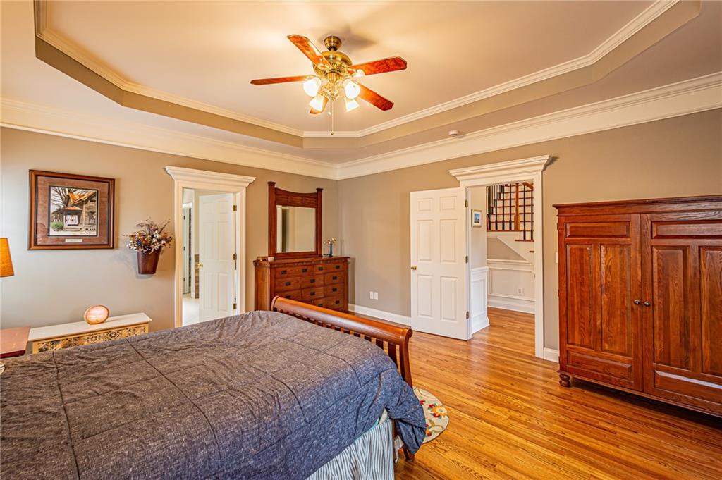 3718 Pebble Creek Point Gainesville, GA 30506 - Photo 43 of 144 a bedroom with a large bed a chandelier and closet