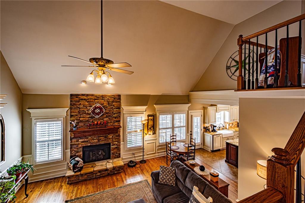 3718 Pebble Creek Point Gainesville, GA 30506 - Photo 56 of 144 a living room with furniture a fireplace and a flat screen tv