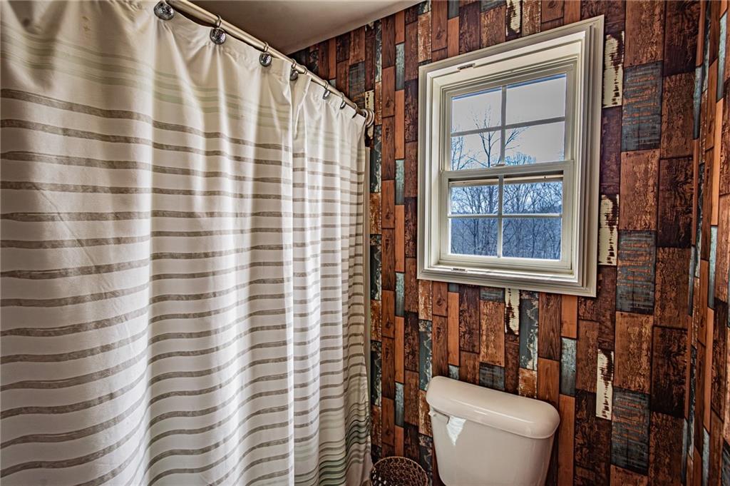 3718 Pebble Creek Point Gainesville, GA 30506 - Photo 68 of 144 a bathroom with a toilet and a shower curtain
