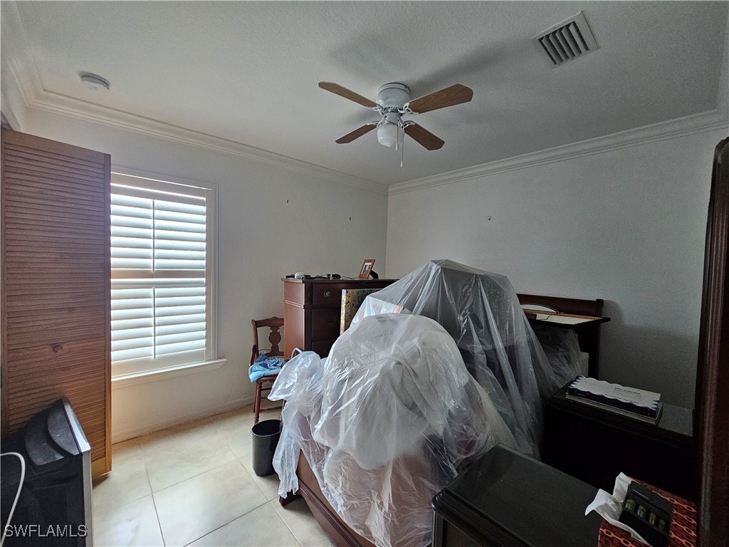 3903 1st Street Southwest Lehigh Acres, FL 33976 - Photo 11 of 25 a bedroom with a bed and a window
