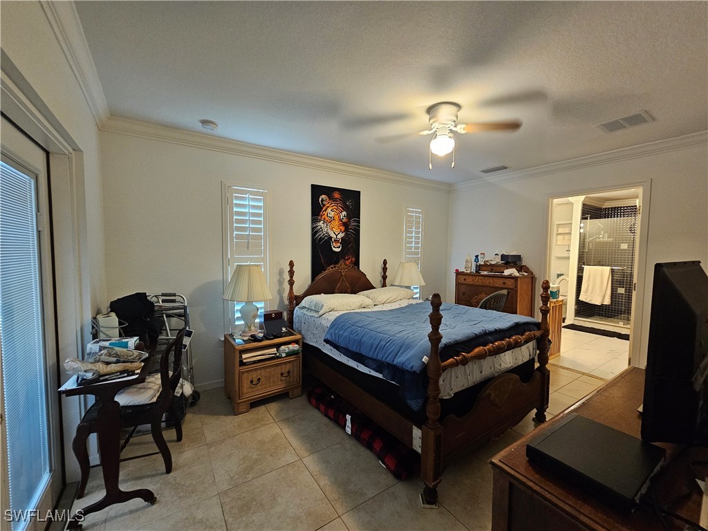 3903 1st Street Southwest Lehigh Acres, FL 33976 - Photo 15 of 25 a bedroom with a bed and a chandelier