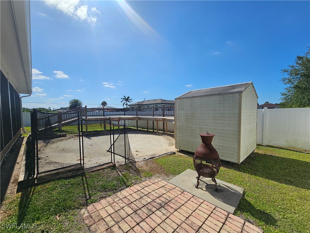 3903 1st Street Southwest Lehigh Acres, FL 33976 - Photo 24 of 25 a view of a chairs and table in the backyard