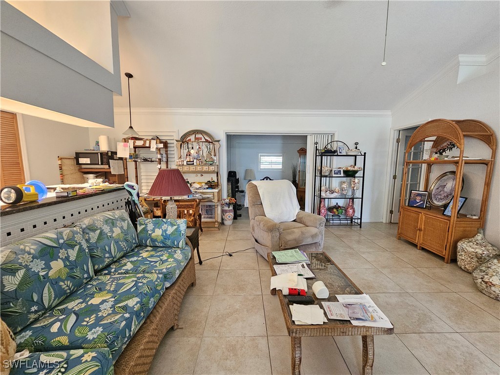 3903 1st Street Southwest Lehigh Acres, FL 33976 - Photo 4 of 25 a living room with furniture a rug and gym equipment