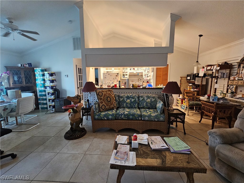 3903 1st Street Southwest Lehigh Acres, FL 33976 - Photo 5 of 25 a living room with furniture a rug and a floor to ceiling window