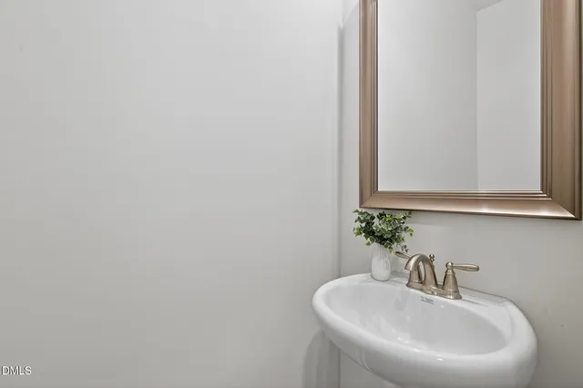 a bathroom with a sink a mirror and a vanity