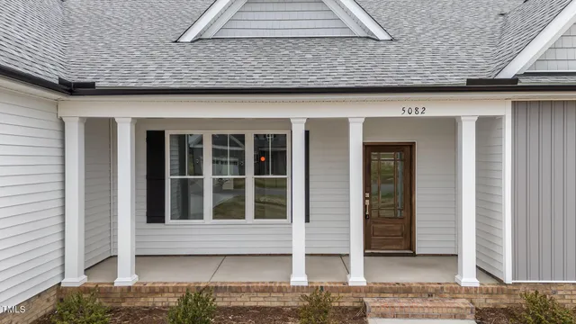 a living room with furniture a rug and a chandelier