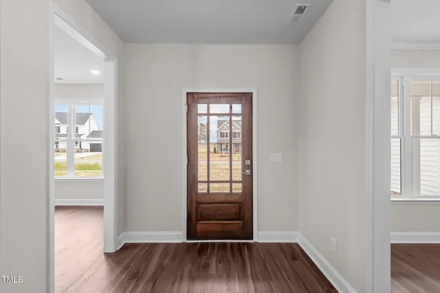 a living room with furniture kitchen view and a chandelier
