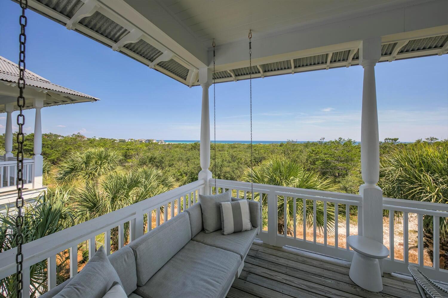 187 Cypress Drive Santa Rosa Beach, FL 32459 - Photo 14 of 58 a view of a balcony with couches and wooden floor