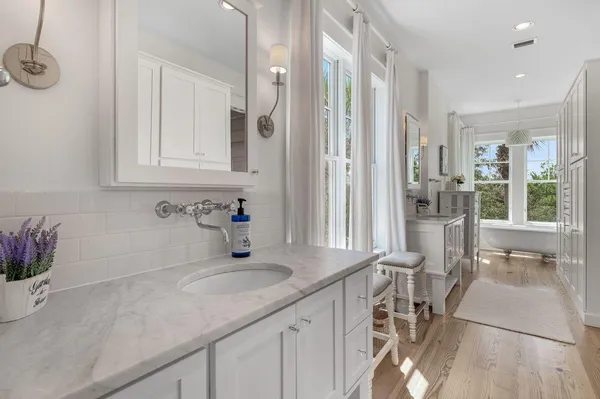 a living room with furniture a fireplace and large windows