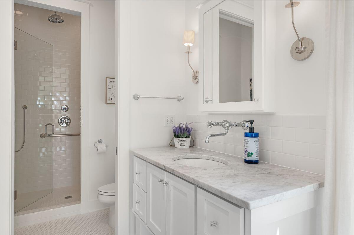 187 Cypress Drive Santa Rosa Beach, FL 32459 - Photo 31 of 58 a bathroom with a granite countertop sink a toilet and shower