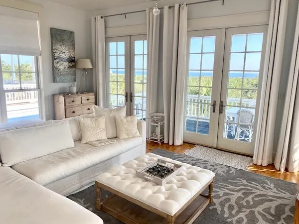 a living room with furniture a rug and a chandelier