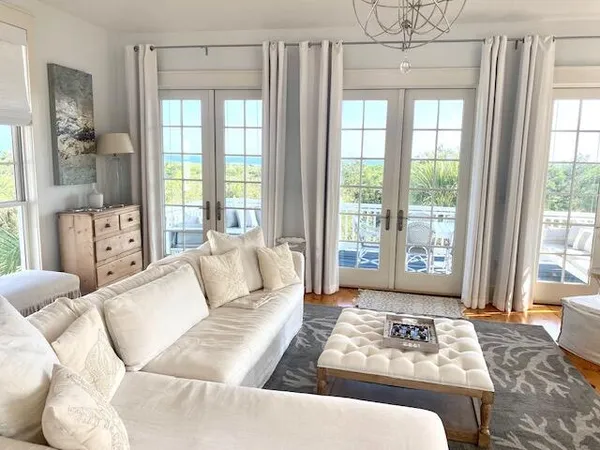 a living room with furniture a fireplace and a chandelier
