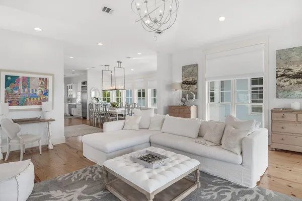 a living room with furniture and a dining table