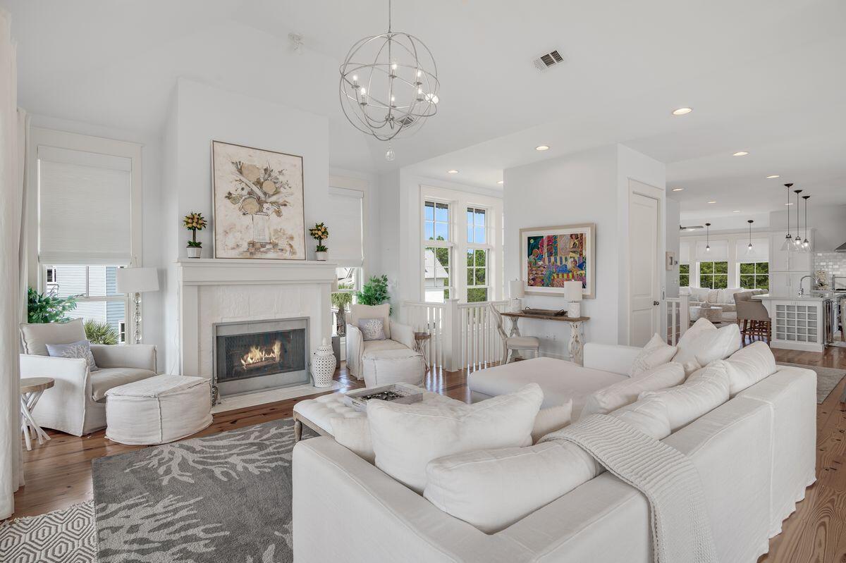 187 Cypress Drive Santa Rosa Beach, FL 32459 - Photo 9 of 58 a living room with furniture a fireplace and a chandelier