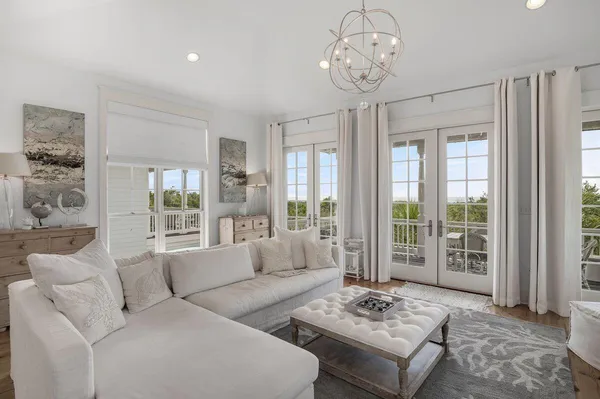 a kitchen with stainless steel appliances kitchen island granite countertop a stove a sink a dining table and chairs with wooden floor