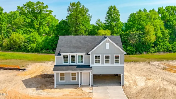 a front view of a house with a yard and porch