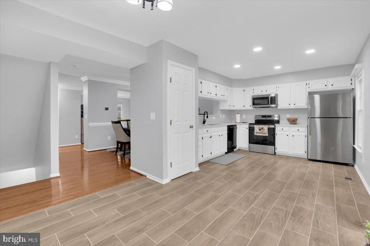 7523 Westmore Drive Springfield, VA 22150 - Photo 11 of 37 a view of kitchen with refrigerator cabinets and wooden floor