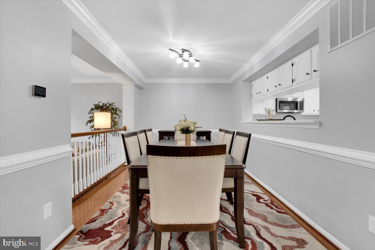 7523 Westmore Drive Springfield, VA 22150 - Photo 8 of 37 a view of a dining room with furniture and a chandelier