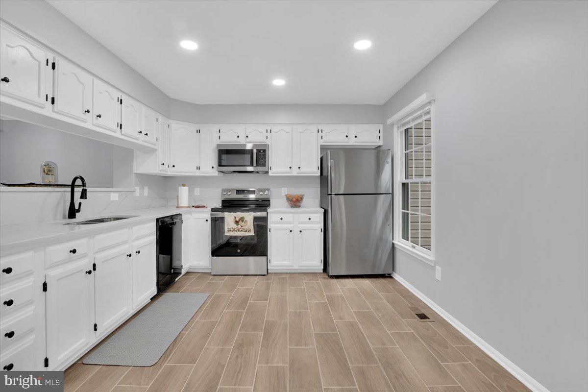 7523 Westmore Drive Springfield, VA 22150 - Photo 10 of 37 a kitchen with stainless steel appliances a refrigerator sink and cabinets