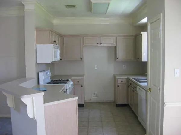 a kitchen with a stove and a refrigerator