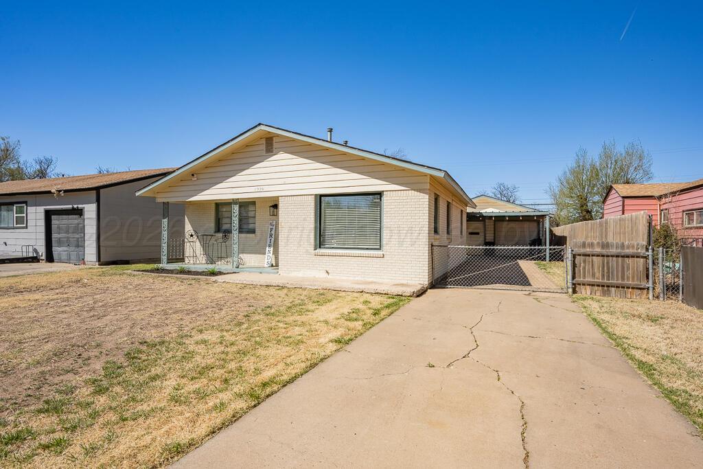 1926 South Highland Street Amarillo, TX 79103 - Photo 1 of 16 a front view of a house with a yard