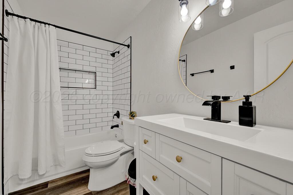 1926 South Highland Street Amarillo, TX 79103 - Photo 11 of 16 a bathroom with a sink a toilet and shower