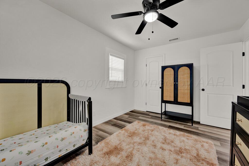 1926 South Highland Street Amarillo, TX 79103 - Photo 13 of 16 a bedroom with a bed and a dresser