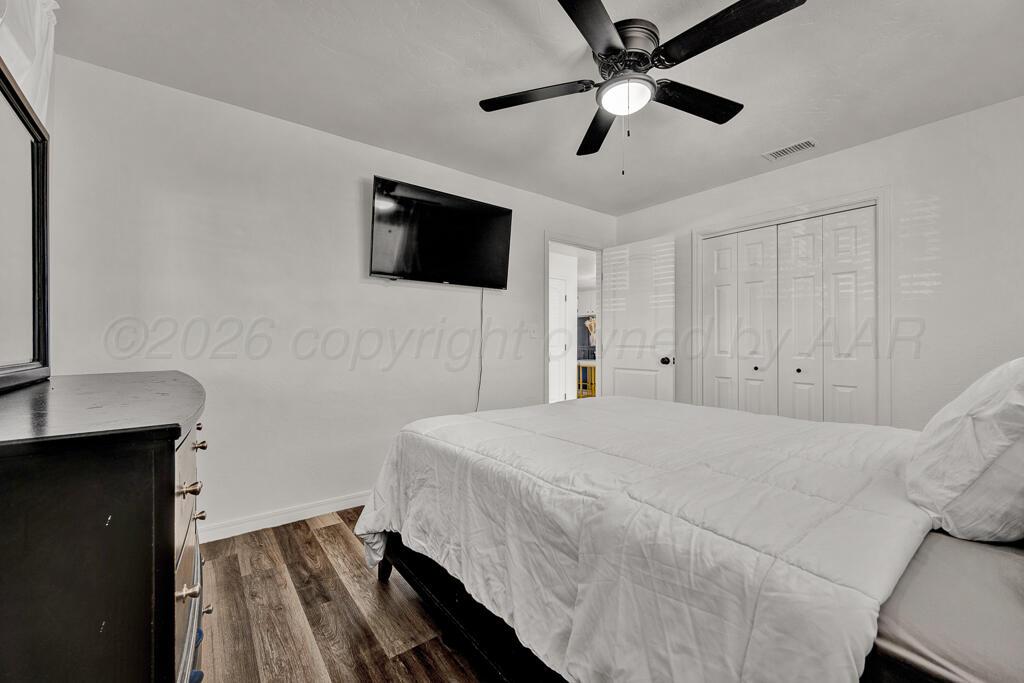1926 South Highland Street Amarillo, TX 79103 - Photo 10 of 16 a bedroom with a bed and a flat tv screen on dresser