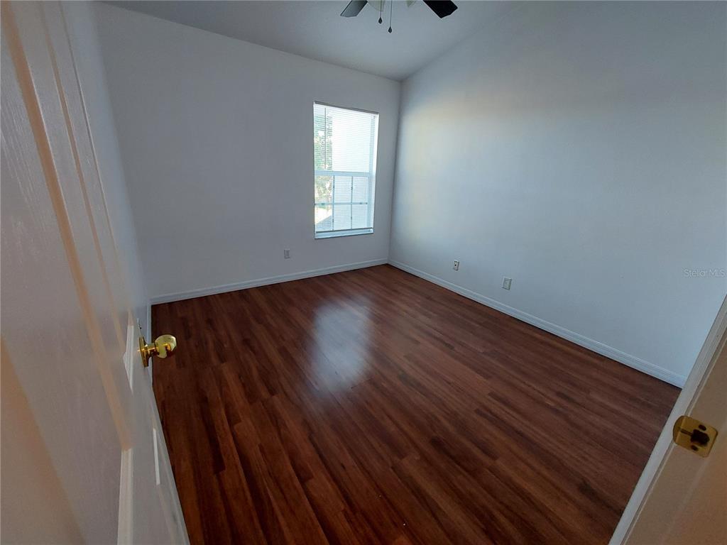 3521 Red Rock Drive Land O Lakes, FL 34639 - Photo 11 of 13 a view of an empty room with wooden floor and a window